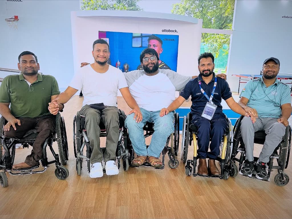 Adaptive athletes holding hands in solidarity at Ottobock arena